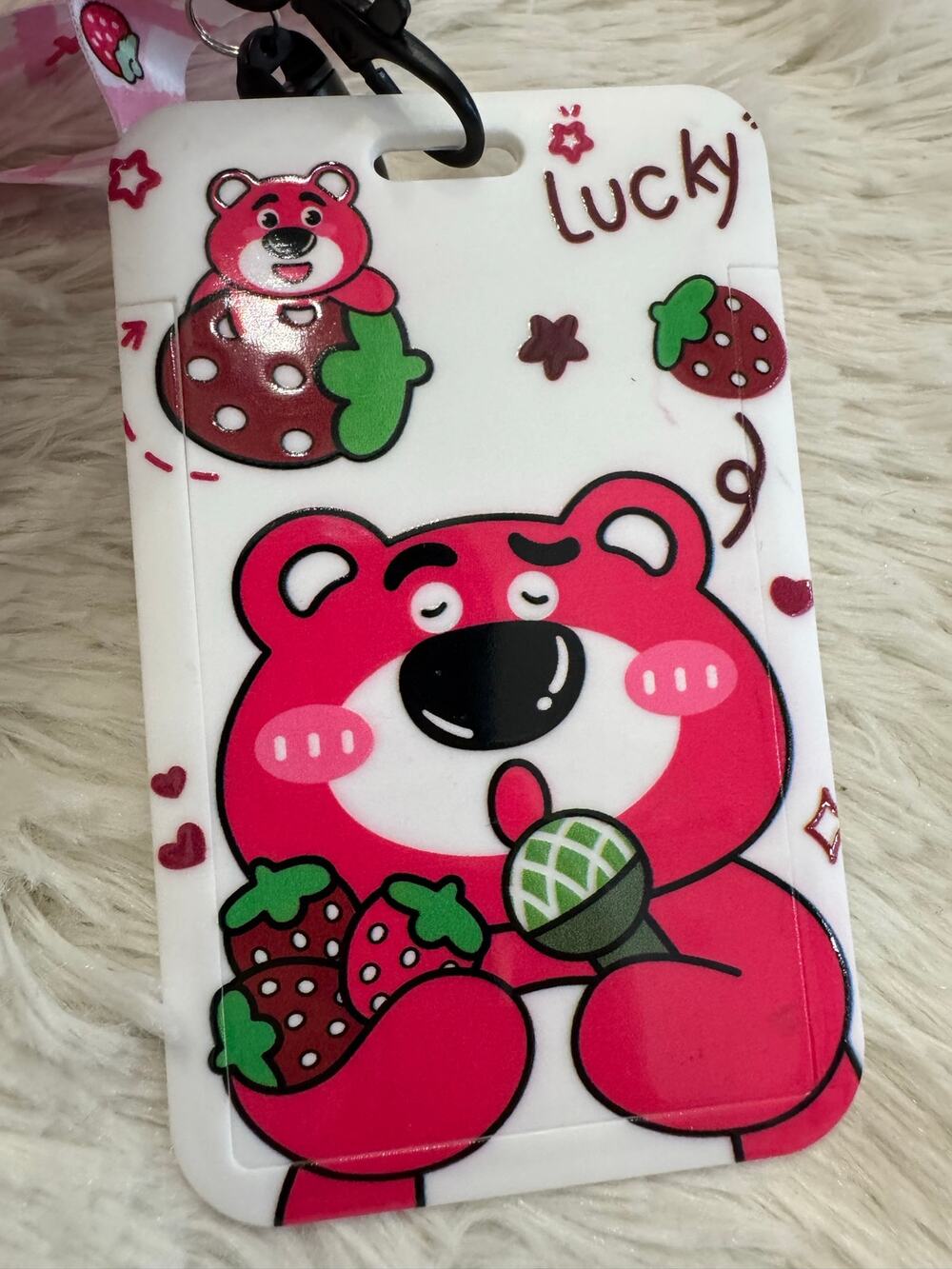 LOTSO Strawberry Bear ID Card Holder with landyard holding a microphone